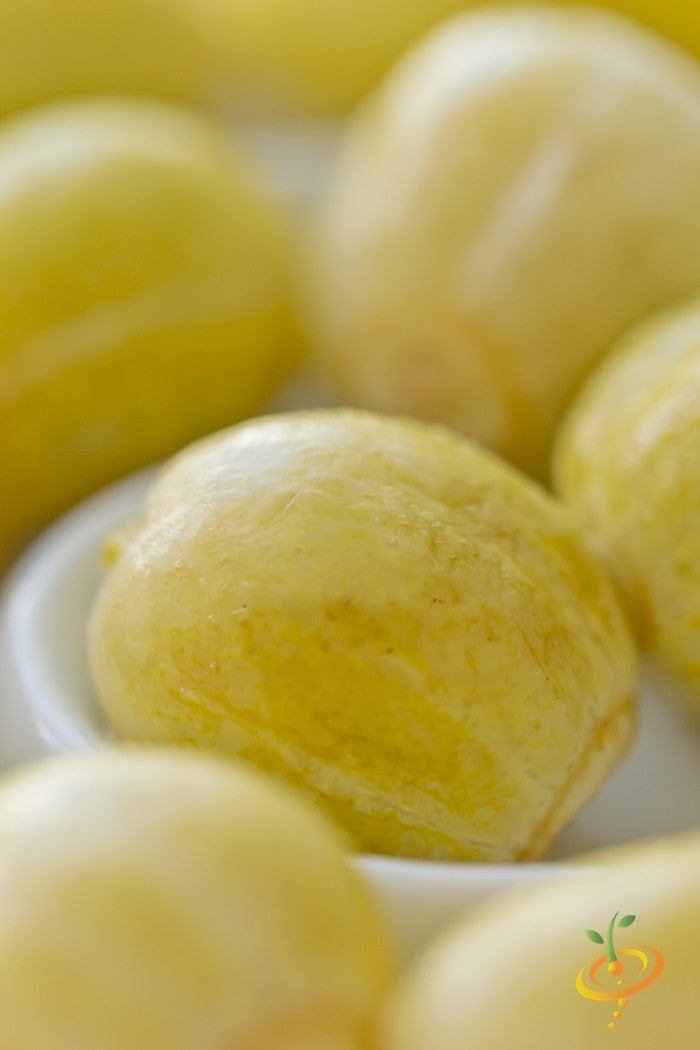 Close-up of bright yellow lemon cucumber seeds with smooth texture
