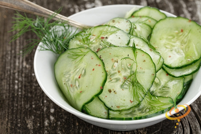 Fresh green cucumber from Ashley Seeds by SeedsNow, showing smooth skin and cylindrical shape on a white background.